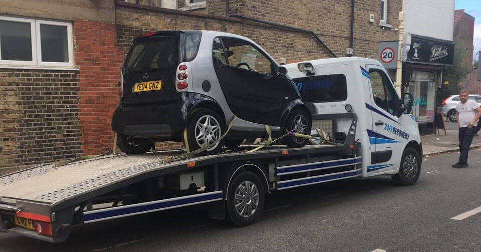 Lonestar recovery truck loaded with a car